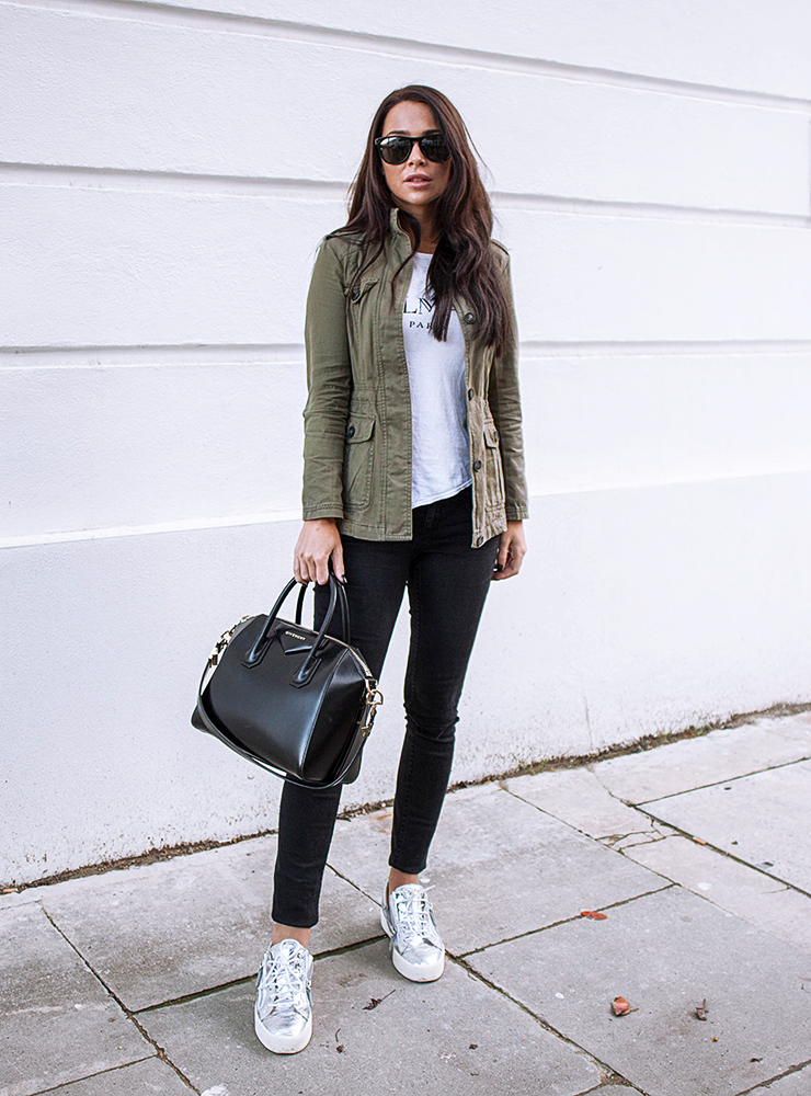 Johanna Olsson wears a classic military style khaki jacket worn with black jeans and metallic print sneakers. Try wearing a similar piece with a skirt or dress to switch up the look but keep that military feel. Shoes: Giuzeppe Zanotti, Jacket: New Look, Top: Balmain, Sunglasses: Olivers People, Bag: Givenchy.